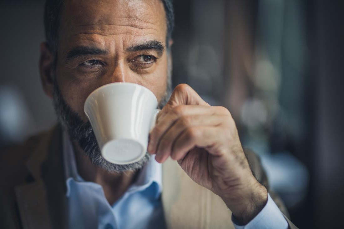 عکس مردی در حال خوردن قهوه